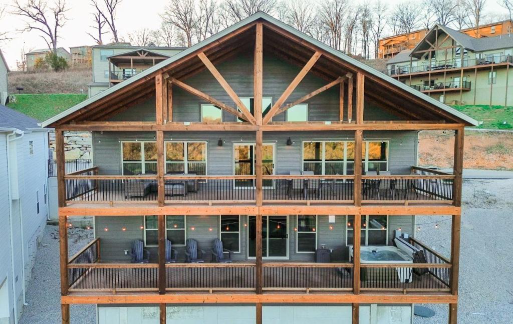 a large house with a wrap around deck at Spacious Rustic Elm Lodge in Branson