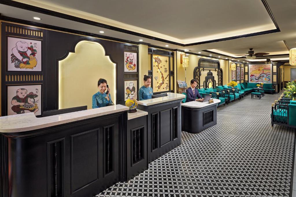 a barber shop with three people sitting at their sinks at Eliana Premio Hotel Hanoi in Hanoi