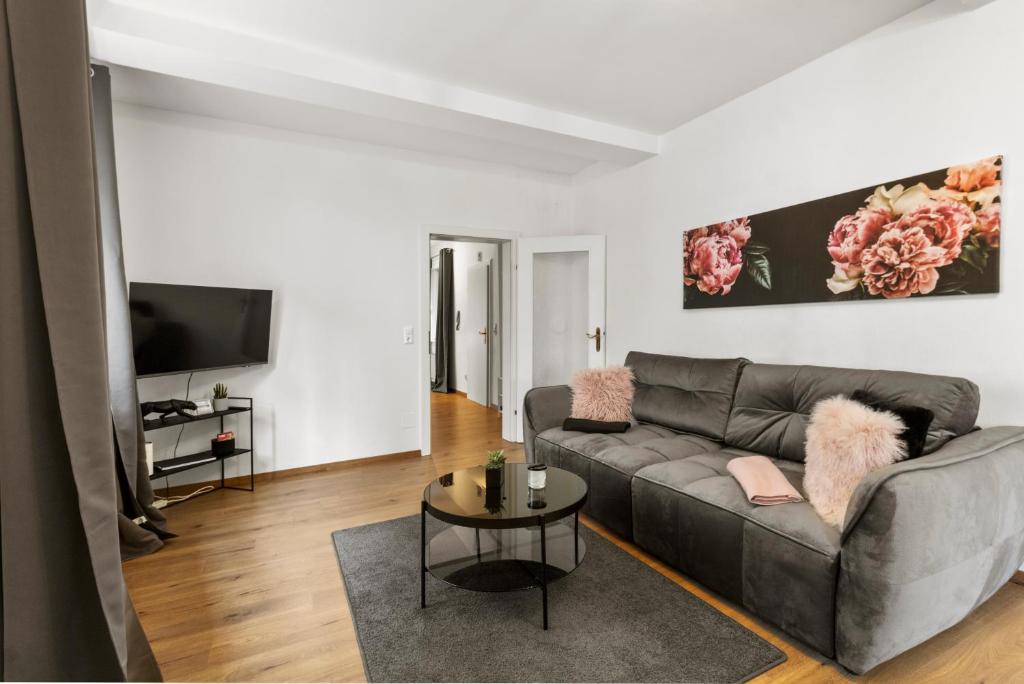 a living room with a couch and a table at FarawayHomes Studios Mautern in Mautern