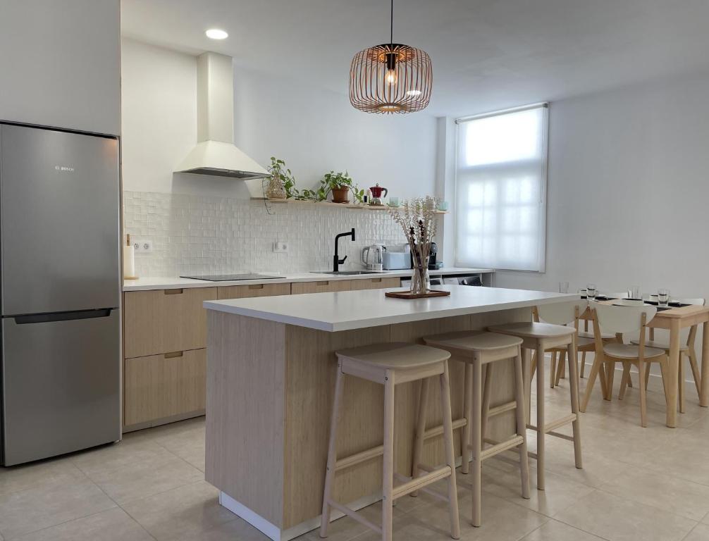 a kitchen with a large island with bar stools at MarketHome Puertito de Guimar in Puertito de Güímar