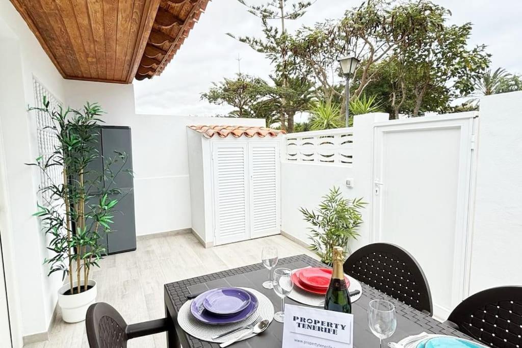 a dining room with a table and chairs on a patio at Calma & Mar in Arona