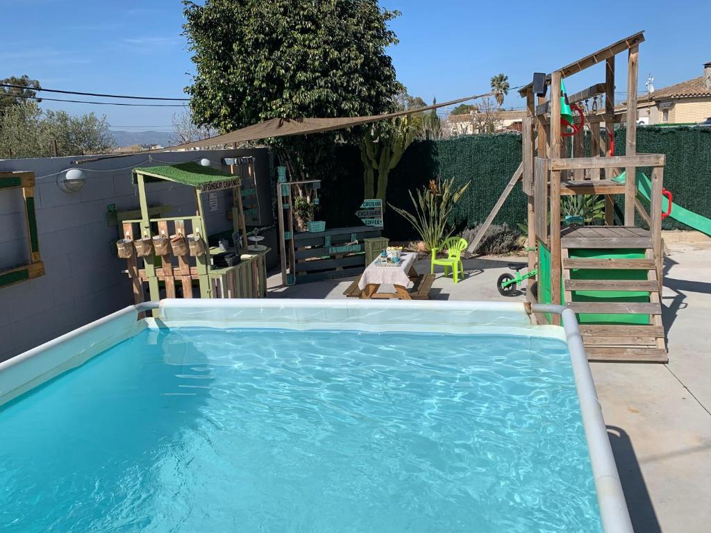 a swimming pool with a ladder and a slide at Casa Enric 2 in Deltebre