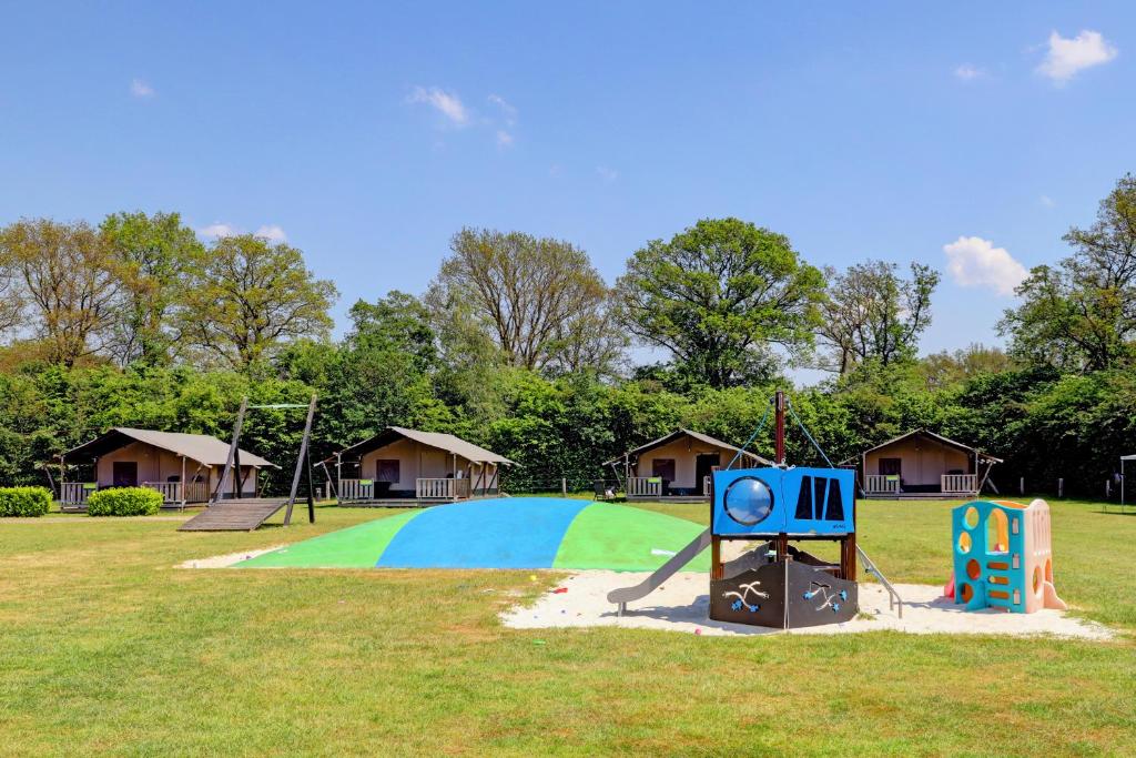 a playground with a slide in a park at Camping Dal van de Mosbeek in Mander