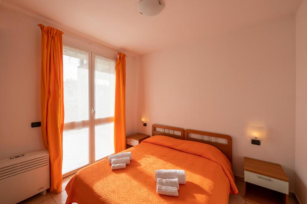Postel nebo postele na pokoji v ubytování Camping Residence & Lodge Orchidea