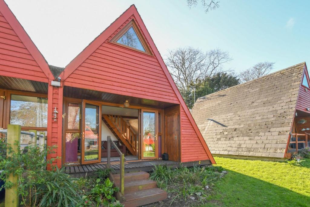 a small house with a red roof at Chalet Two in Deal