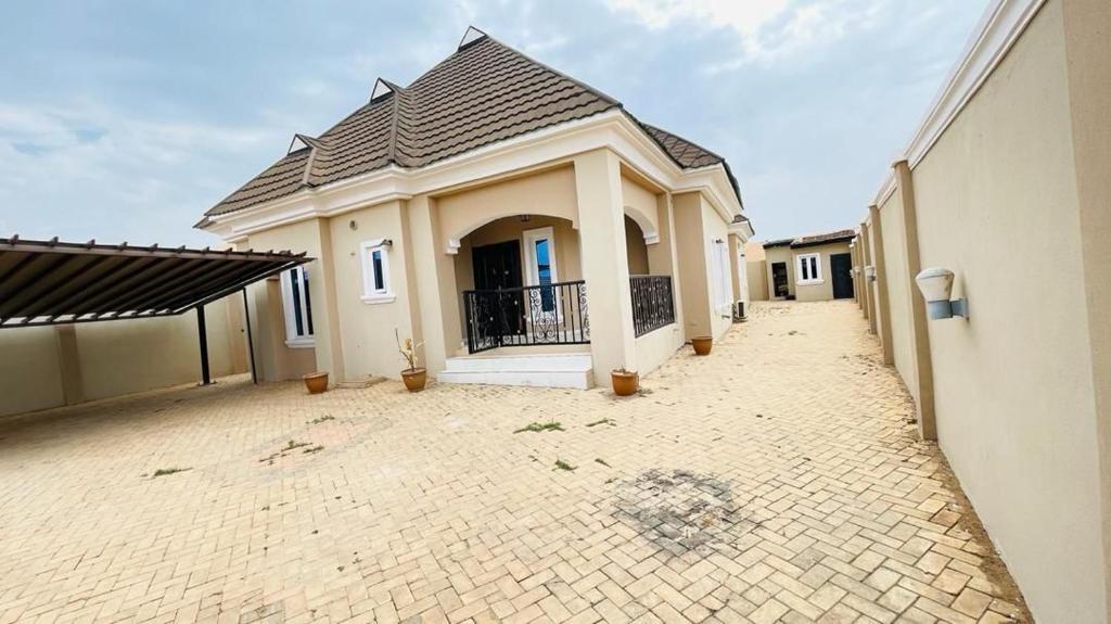 a house with a tile roof on a driveway at House 5 in Ilorin