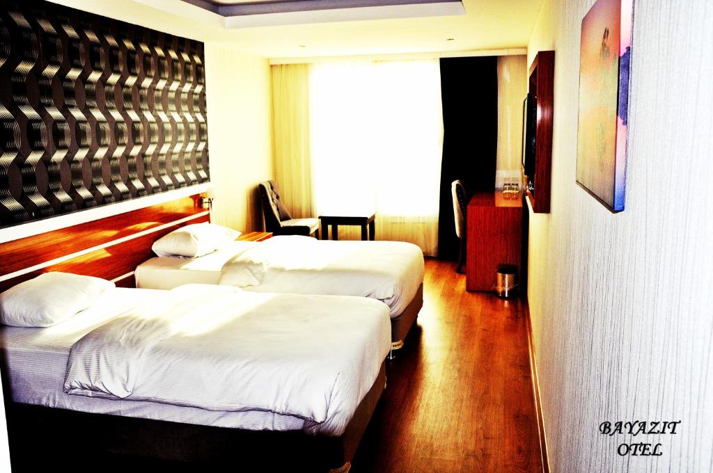 A bed or beds in a room at Bayazıt Hotel