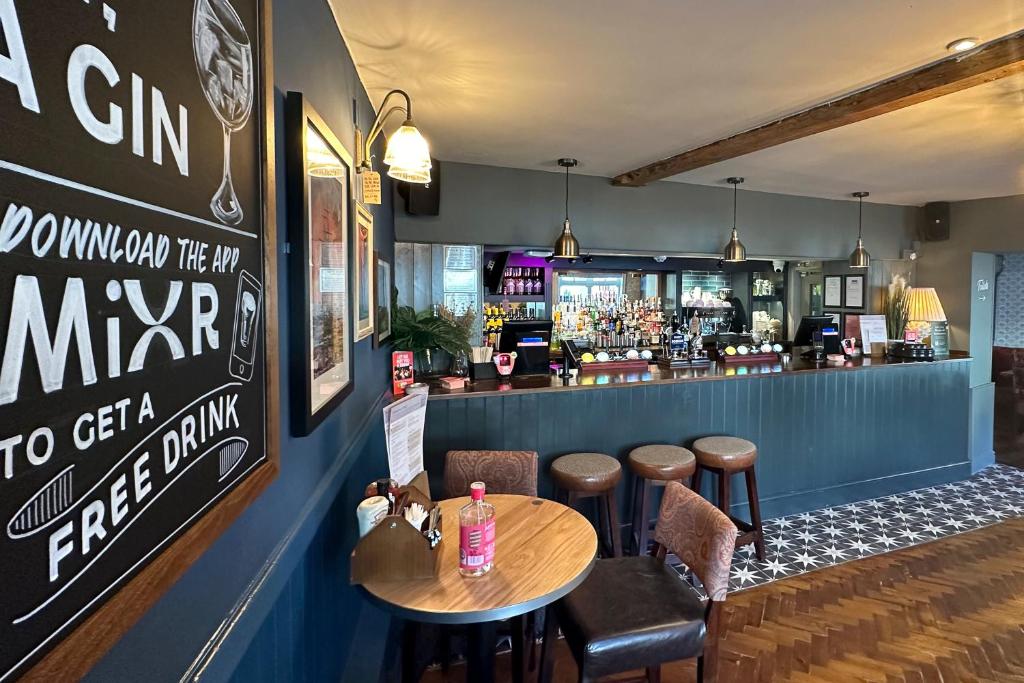 a bar with a table and chairs and a counter at The Lobster in Sheringham