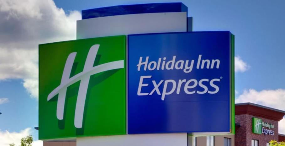 a sign for a holiday inn express on the side of a building at Holiday Inn Express Columbus Northeast, an IHG Hotel in Columbus