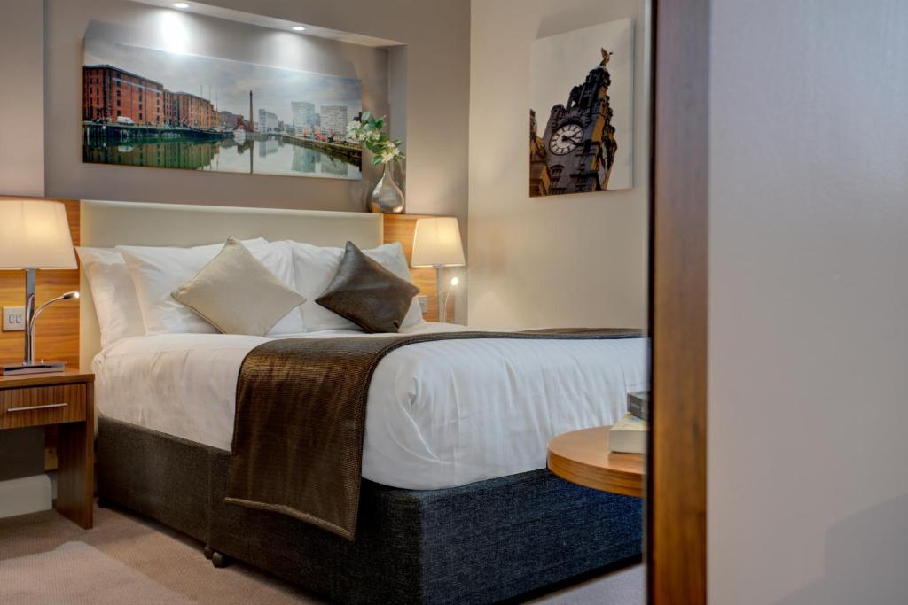 a bedroom with a bed with white sheets and pillows at Heywood House Hotel, BW Signature Collection in Liverpool