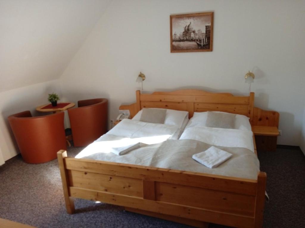 A bed or beds in a room at Hotel Koliba