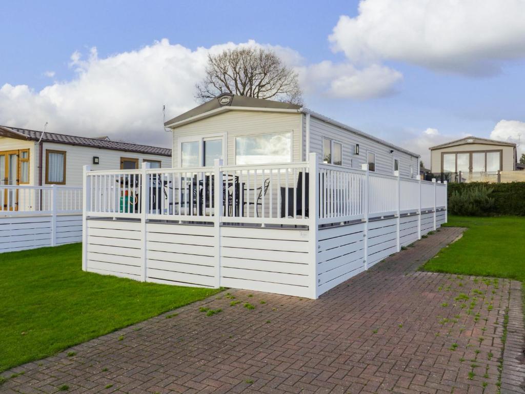 a white house with a white fence at Seasalt in West Mersea