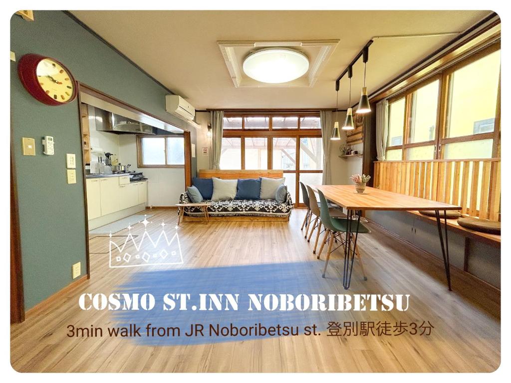 a living room with a table and a couch at Cosmo St Inn Noboribetsu 3min walk from JR Noboribetsu st in Tomiura