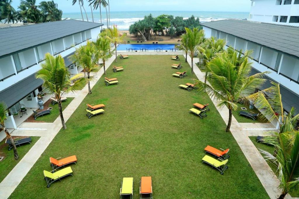 an overhead view of a large lawn with lounge chairs at Rathna Beach Wadduwa in Kalutara