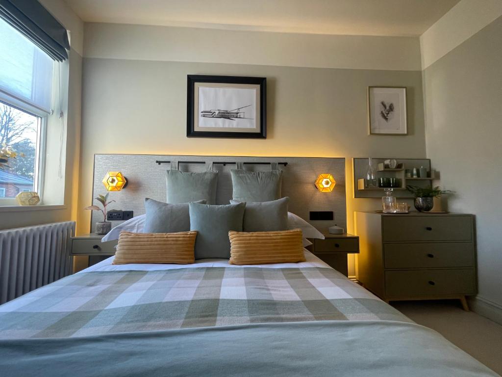a bedroom with a large bed with two pillows at Cosy Room In Altrincham in Hale