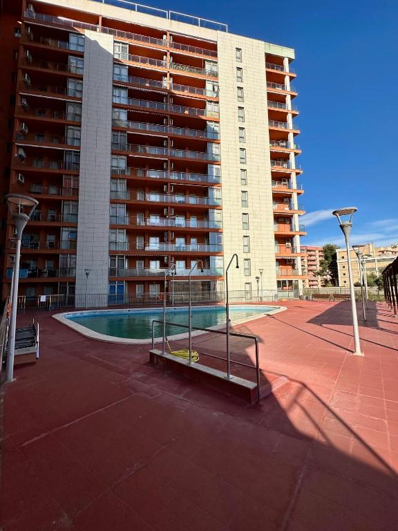 a large building with a swimming pool in front of a building at Apartamento Algaida REF.004 in Oropesa del Mar