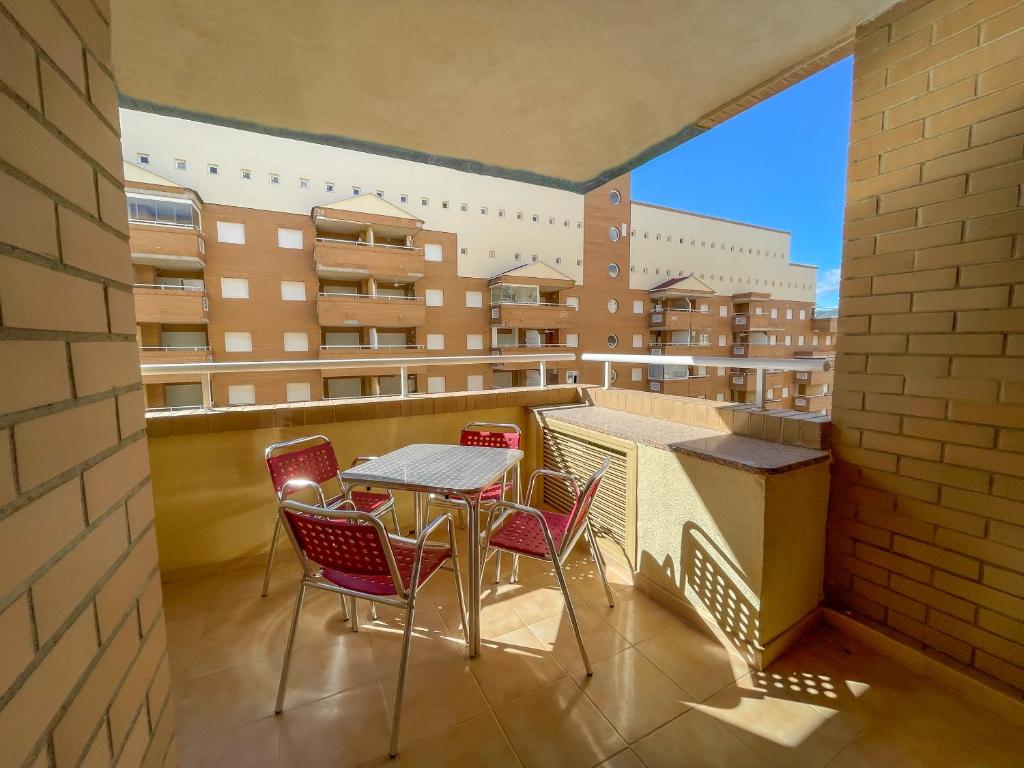 a balcony with a table and chairs on a balcony at Apartamentos Caribe Marina D’Or 3000 in Oropesa del Mar