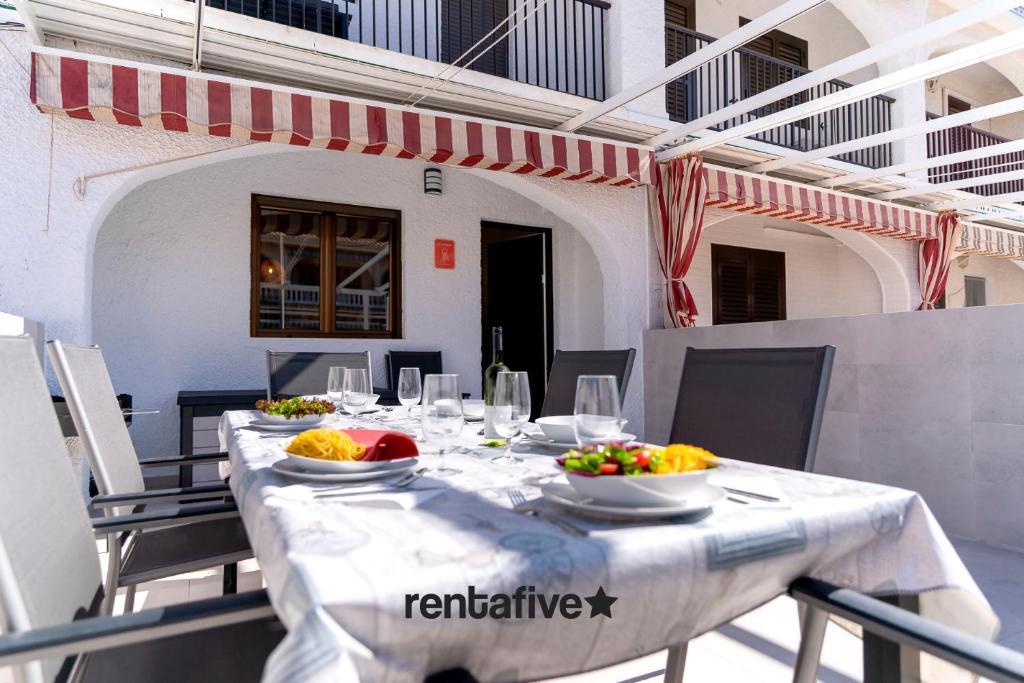 a table with plates of food on top at rentafive - Gran casa reformada - Terraza in Santa Pola