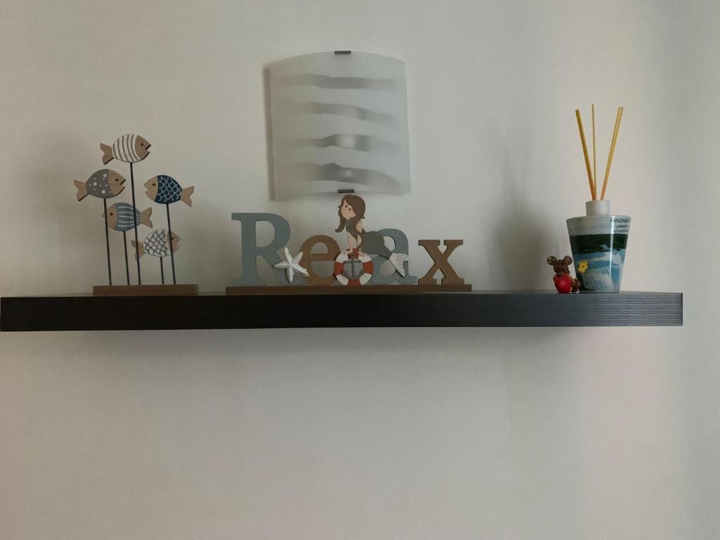 a shelf with some figurines on a wall at Casa Antico Barbiere in Chioggia