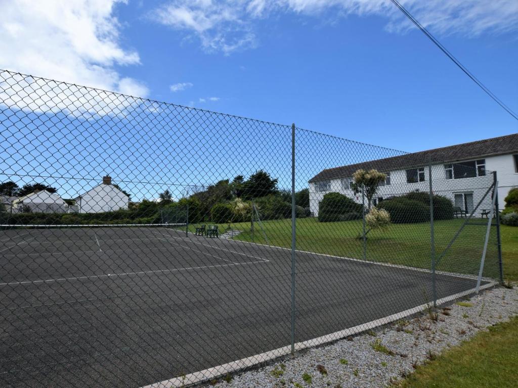 a tennis court with a net at 2 Bed in Bude 53635 in Bude