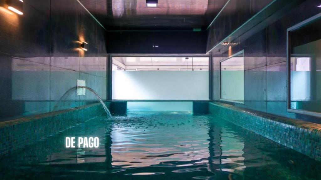 a pool of water in a building with a pool of water at Hotel Playa Brava in Punta del Este