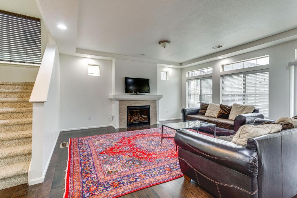 a living room with a couch and a fireplace at Spacious Denver Vacation Home about 18 Mi to Downtown! in Aurora