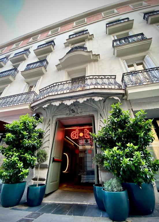 a building with potted plants in front of a door at chic&basic dot in Madrid