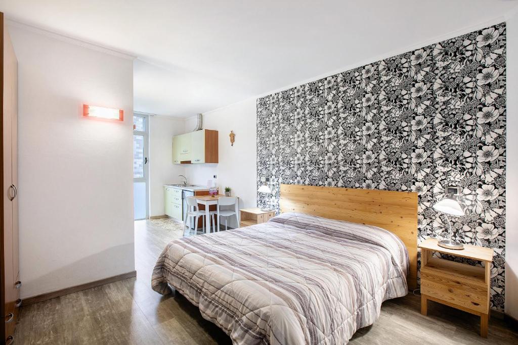 En eller flere senge i et værelse på Alpen Pila Residence Loft 6