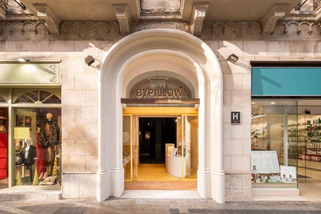 a store front with an archway in a building at BYPILLOW Mothern in Barcelona