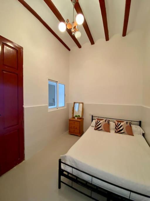 a bedroom with a bed and a red door at Casa Benicassim Completa in Benicàssim