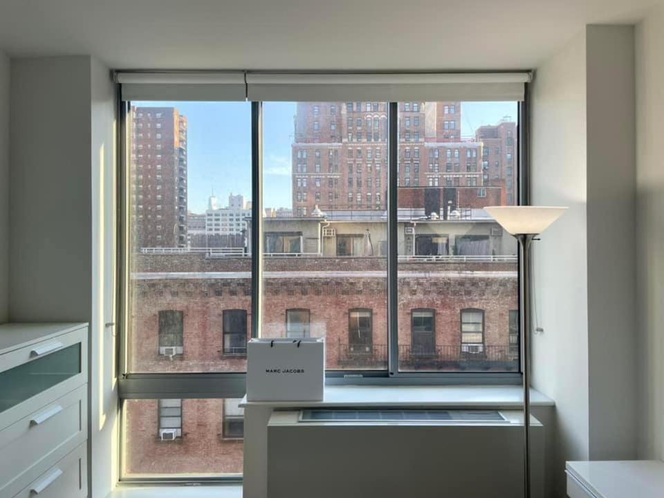 a room with a window with a view of a building at 2 bedrooms Chelsea apartment - Manhattan in New York