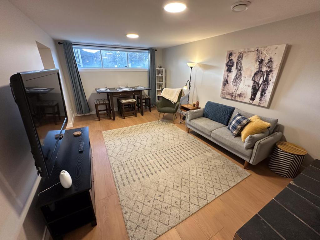 a living room with a couch and a table at Renovated 2 Bedroom Suite w/ King Bed in Kamloops