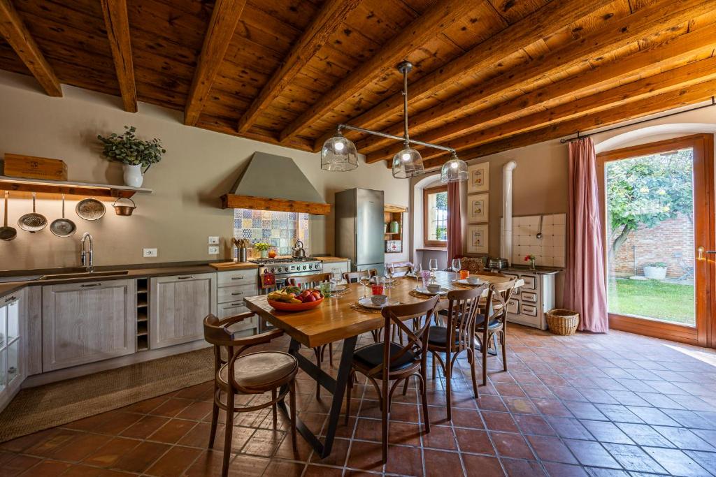a kitchen with a long table and chairs in it at Villa Carlotte - quiet and comfort in Pastrengo