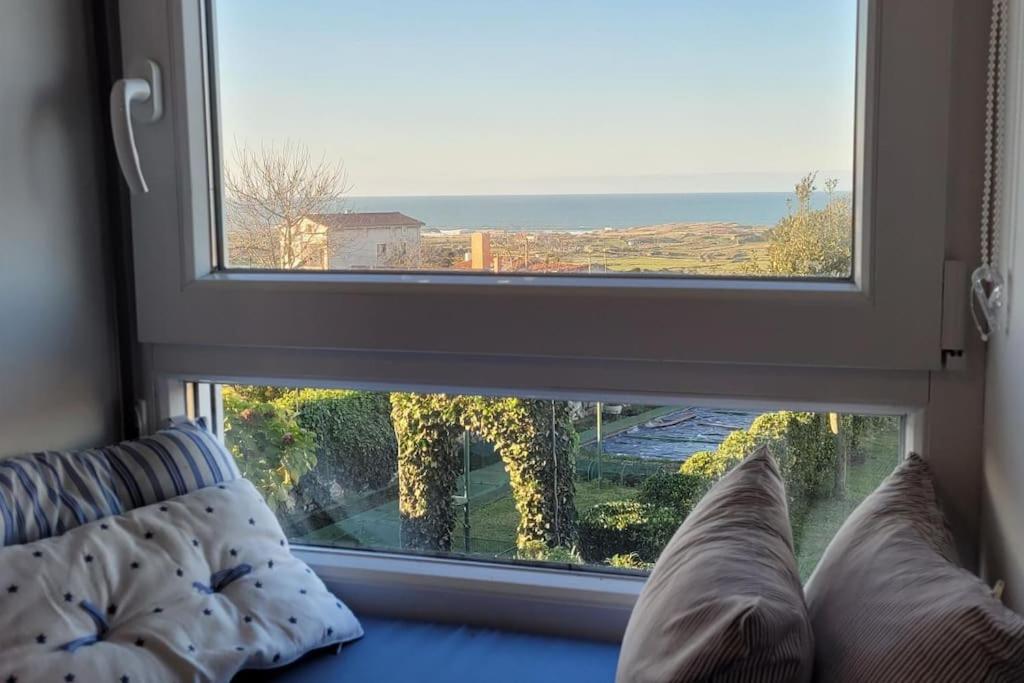 a room with a window with a view of the ocean at Villa de Cueto in Santander