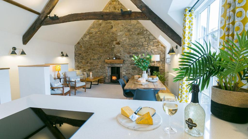 a living room with a table with wine glasses at Custom Mews in Beaumaris
