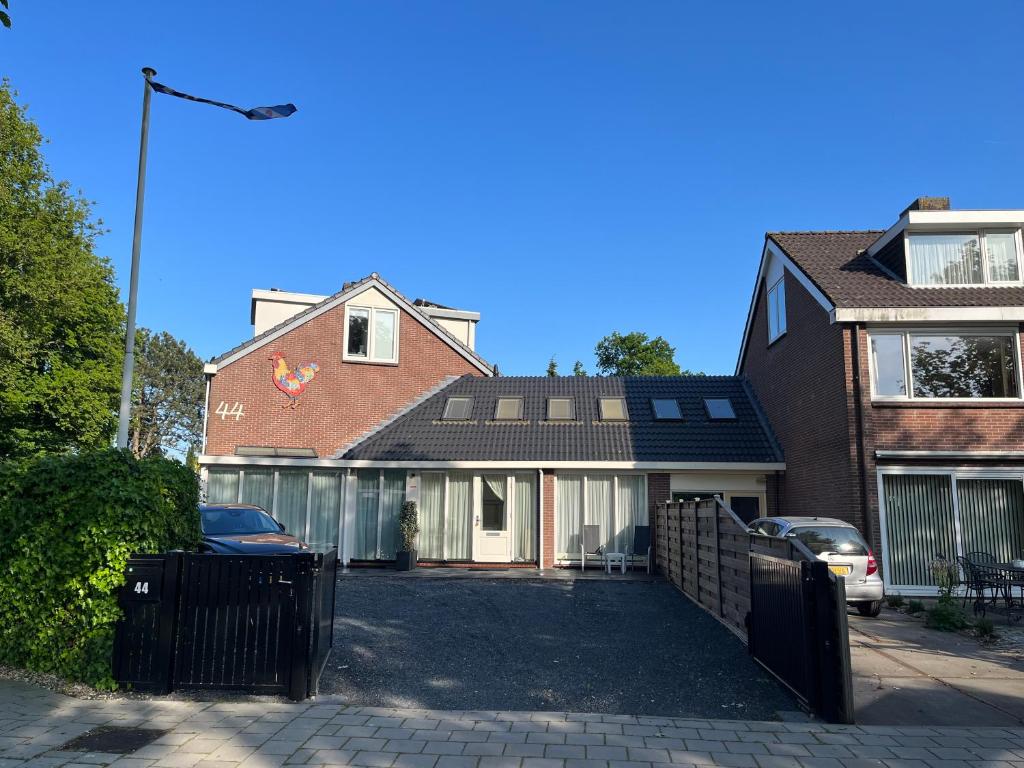 a house with a parking lot in front of it at Appartement Lijnden in Lijnden