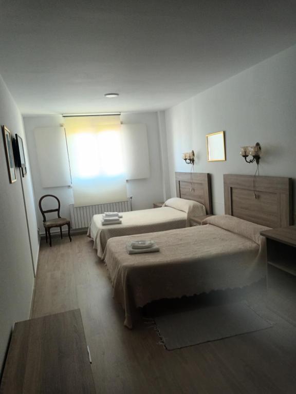 Posteľ alebo postele v izbe v ubytovaní Hostal padornelo