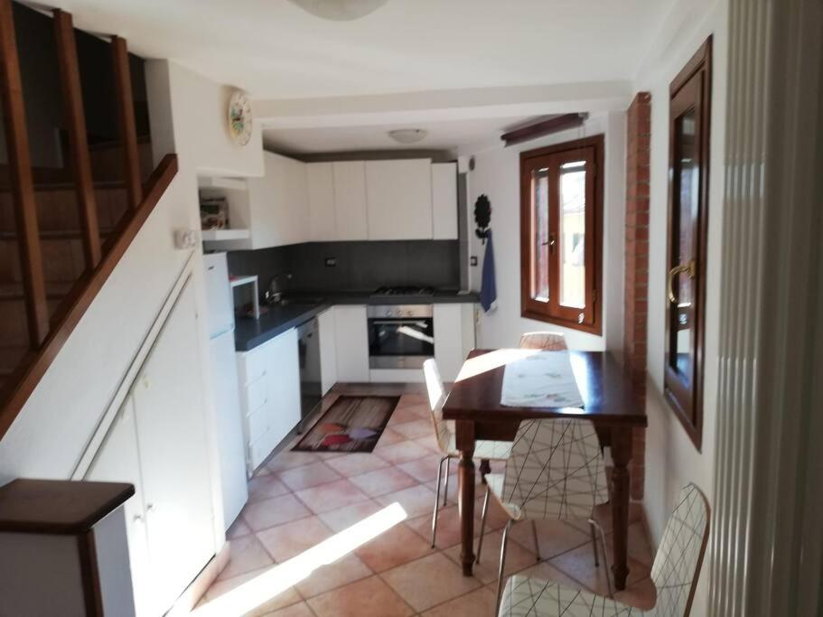 a kitchen with a table and chairs in a room at La Casetta in Porto Santo Stefano