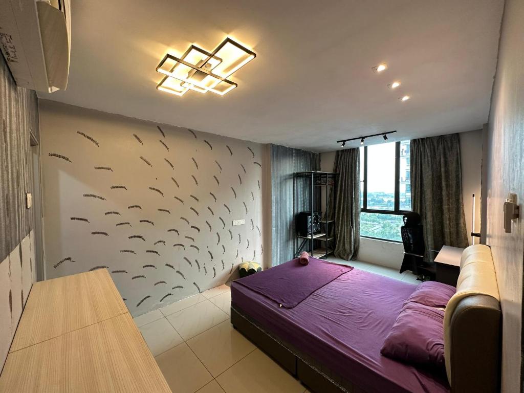 a bedroom with a purple bed and a wall with fish painted on it at Blossom - Casa Kayangan Meru Ipoh by GOSWELL in Ipoh