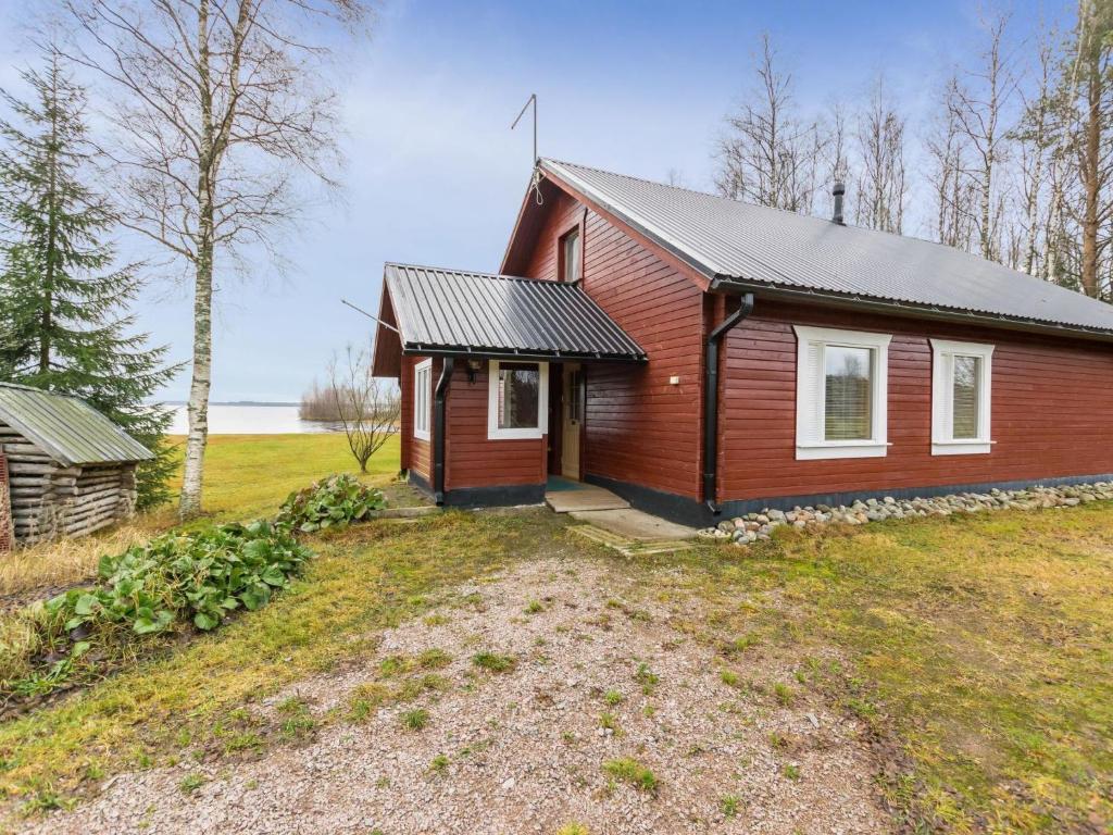 a small red house on a grassy field at Holiday Home Pepi by Interhome 