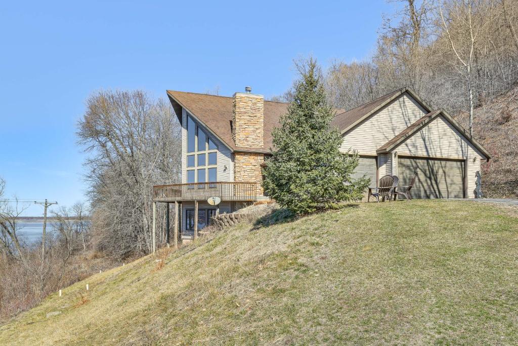 a house on top of a hill with a tree at Spacious Stoddard Retreat on Mississippi River! 