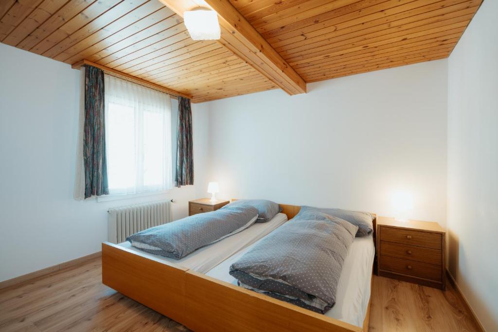 a bedroom with a bed with two pillows on it at Apartment Sonne in Amden