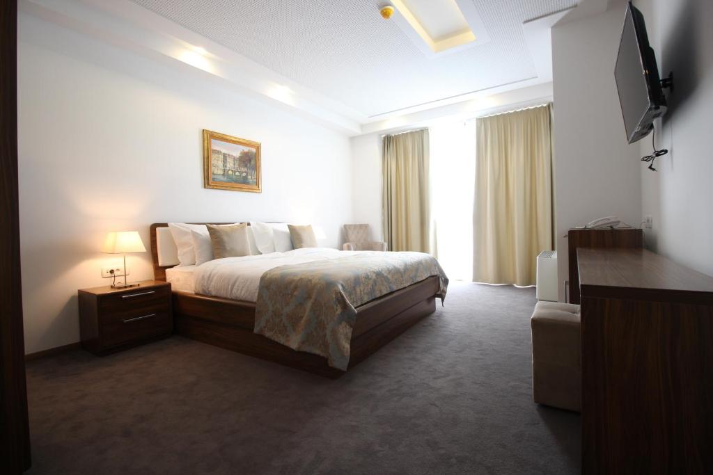 Postel nebo postele na pokoji v ubytování Hotel Royal Gold City