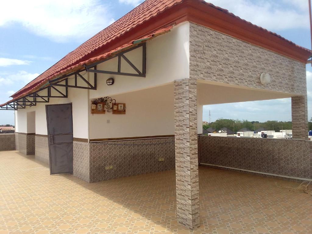 a building with a large window on a roof at BARAKAH ESTATE APARTMENTS in Sere Kunda