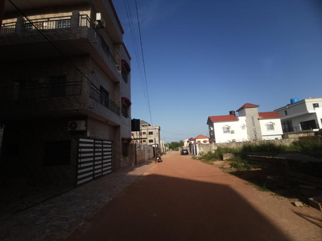 an empty street in a city with buildings at BARAKAH ESTATE APARTMENTS in Sere Kunda
