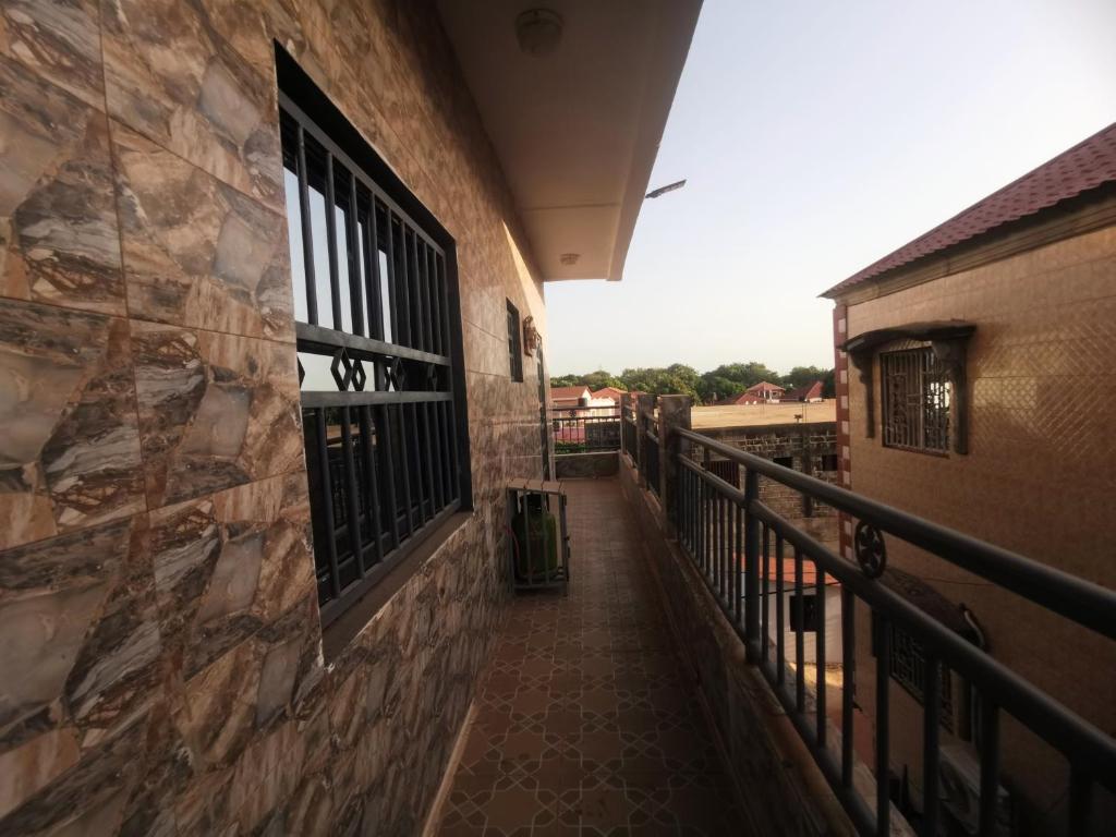 a balcony of a building with a walkway at BARAKAH ESTATE APARTMENTS in Sere Kunda