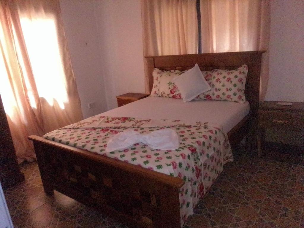 a bedroom with a bed with two bows on it at BARAKAH ESTATE APARTMENTS in Sere Kunda