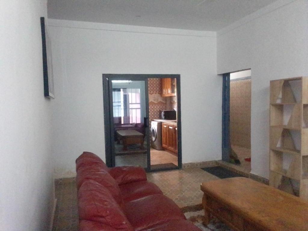 a living room with a couch and a mirror at BARAKAH ESTATE APARTMENTS in Sere Kunda