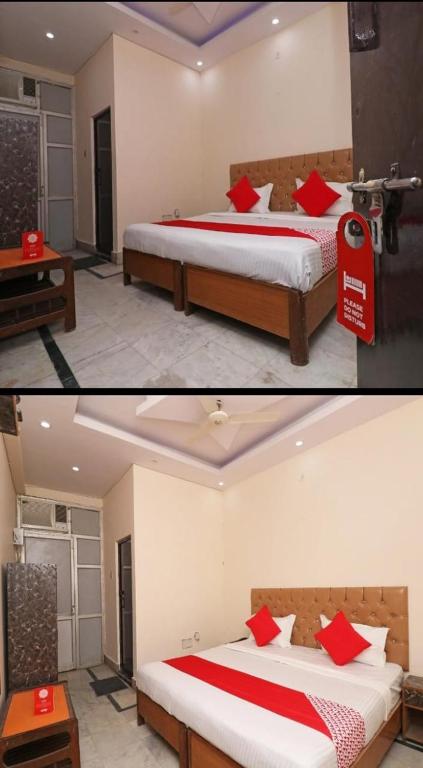 2 Betten mit roten Kissen in einem Zimmer in der Unterkunft Hotel moon place in Lucknow