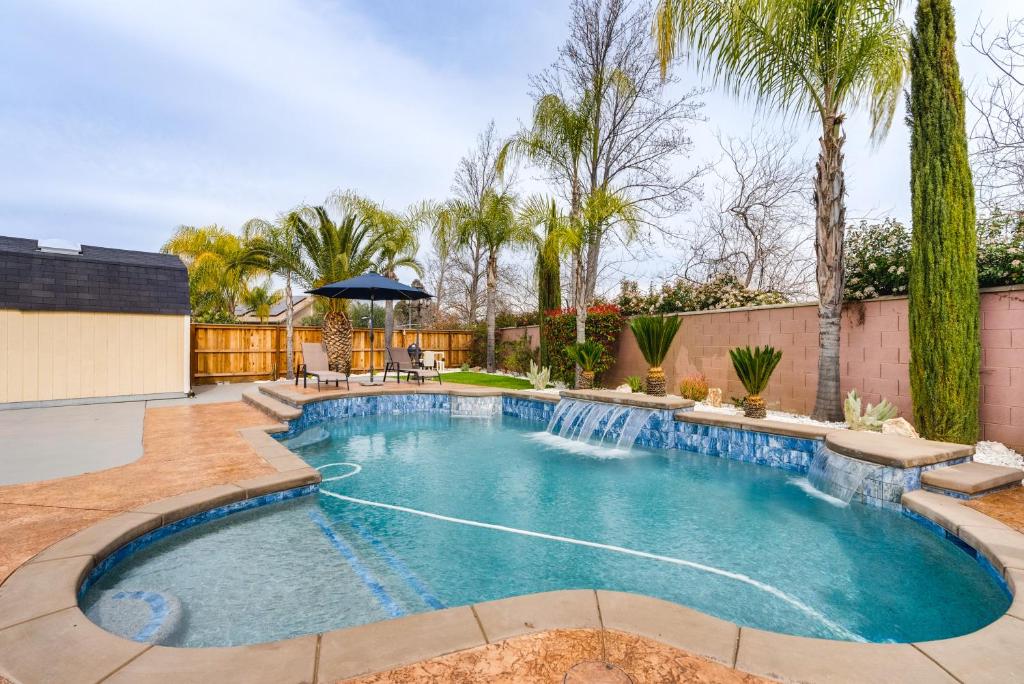 a swimming pool in a yard with trees at Spacious Clovis Vacation Rental with Outdoor Oasis! in Clovis